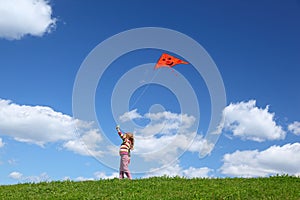 Little girl starts air serpent in sky