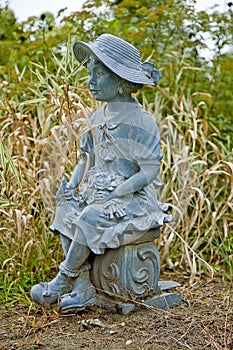 Little Girl Statue in Dying Garden