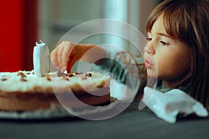 Little Girl Stealing Chocolate Chips from Cake