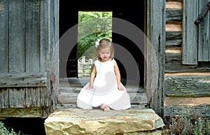 Little Girl on steps of Cabin