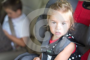 Little Girl Strapped Into A Childs Safety seat