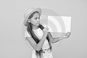 Little girl straw hat showing blank paper copy space, be aware of concept