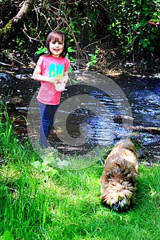 Little Girl by Stream with Doggie