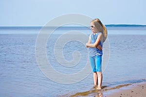 Little girl in a striped vest and hat