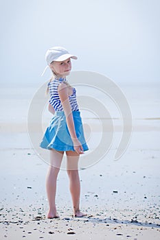 Little girl in a striped vest and hat