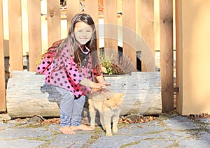 Little girl stroking a cat