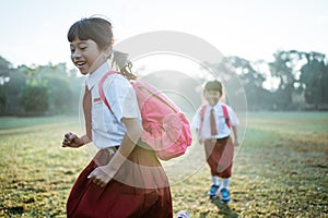 little girl student running together while going to their school