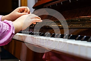 Little girl studing to play the piano photo