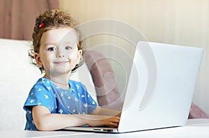 Little girl is studying remotely. online training. children and internet. Distance learning online education.