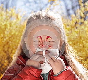 Little girl suffering from runny nose as allergy symptom outdoors. Sinuses illustration