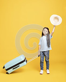 little girl with suitcase going on vacation