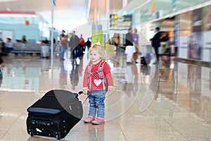 Little girl with suitcase travel in the airport