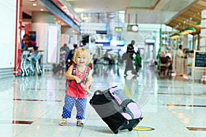 Little girl with suitcase travel in the airport