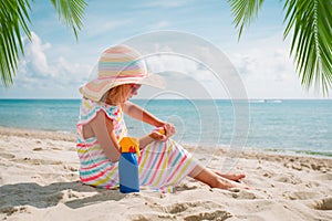 little girl with suncream at beach vacation, sun protection