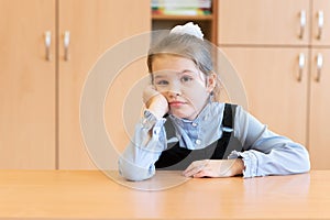 Little girl in a sundress, misses her desk