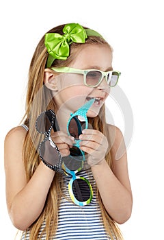 Little girl in sundress several sunglasses