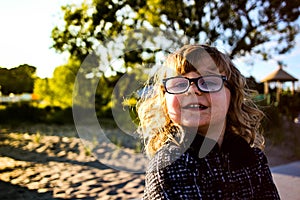 Little girl with sunglasses on beach at resort