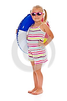 Little girl with sunglasses and inflatable ring