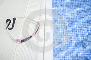 Little girl sunglasses over swimming poolside