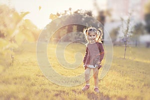 Little girl in sunset backlight