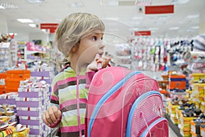 Little girl in supermarket choose footwear