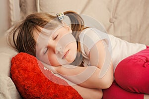 Little girl with sweet dreams sleeping in the chair