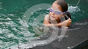 Little girl swim underwater in swimming pool. Slow Motion