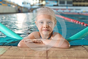 Little girl with swimming noodle