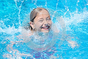 Little girl swimming at the pool