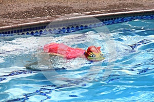 Little girl swimming in pool