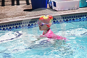 Little girl swimming in pool