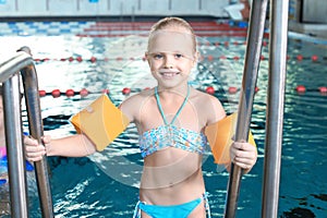 Little girl with swimming sleeves