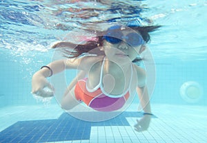 Little girl swimming underwater