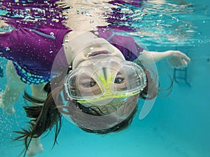 Little girl swimming underwater having fun