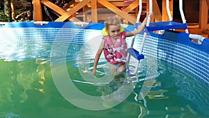 Little girl swims in the pool