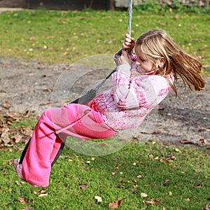 Little girl on a swing