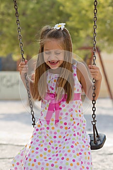 Little girl swinging in the park