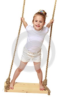 Little girl swinging on a swing