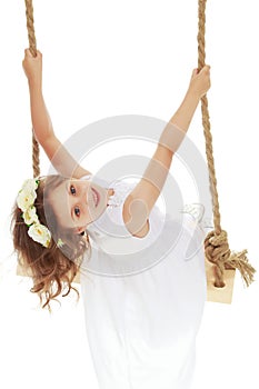 Little girl swinging on a swing