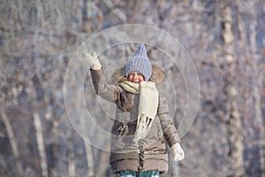 Little girl swings by hand in winter park