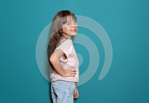 Little girl in t-shirt on color background