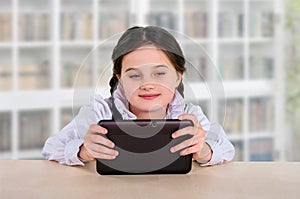 Little girl with a tablet. Communication, school education, games of a child, a teenager with a modern device. interactive social