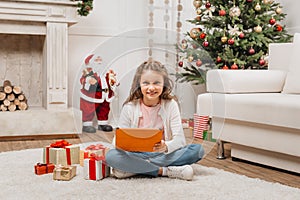 Little girl with tablet and gifts