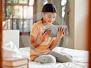 Little girl, tablet and smile on bed for entertainment, education or learning while relaxing at home. Happy female child