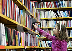 Little girl takes a book