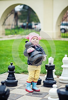 Little girl taking a chessman