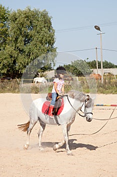 Little Girl Taking Horseback Riding Lessons