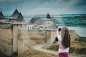 Little girl taking a photo in front of Khotyn photo