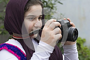 Little Girl Is Taking Photograph by An old Analogue Camera Strap