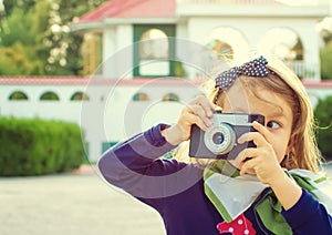 Little girl taking photos outdoor